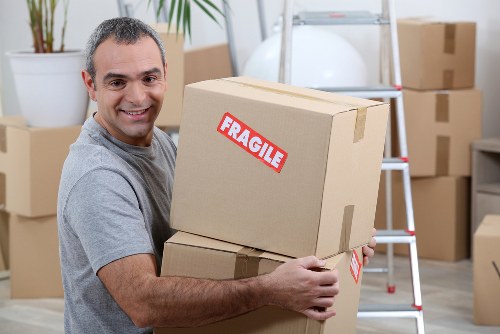 Movers carrying boxes through a residential building in St Johns Wood