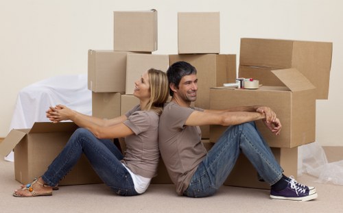 Workers protecting furniture and maintaining safe movement through a property