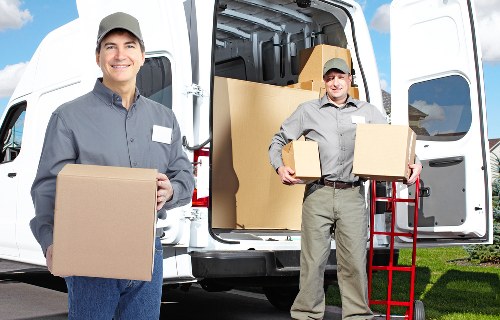 Mover wearing PPE while handling furniture during a relocation